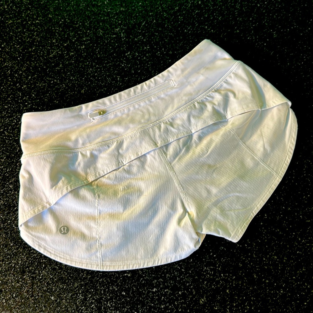 Lululemon Speed Up Low Rise white shorts with 2.5" inseam.